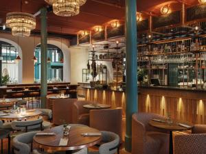 a restaurant with tables and chairs and a bar at Vana Spa Snäckviken by Elite - A proud member of The Leading Spa Hotels of Sweden in Södertälje