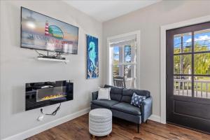 a living room with a couch and a fireplace at Saltwater Pony in Black Point Landing