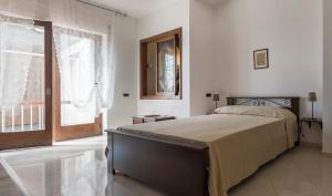a bedroom with a bed and a large window at Minori Apartment in Minori