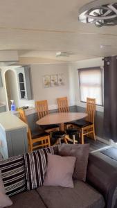 a living room with a table and chairs and a couch at Waterside Haven at Cleethorpes Beach Free Wi-Fi 2 Toilets in Cleethorpes