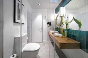 a bathroom with a toilet and a sink at HOVIMA Suites Costa Adeje in Adeje