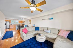 a living room with a couch and a ceiling fan at Water's Edge in Chincoteague