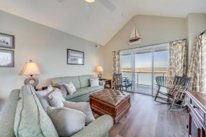 a living room with a couch and a view of the ocean at Sunset Bay Villa 319 - Bella Vista in Chincoteague +24 photos