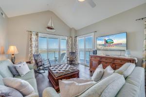 a living room with a couch and a tv at Sunset Bay Villa 319 - Bella Vista in Chincoteague