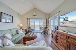 a living room with a couch and a tv at Sunset Bay Villa 319 - Bella Vista in Chincoteague