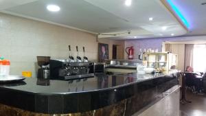 a kitchen with a bar with a counter top at Hôtel Marina in Tetouan