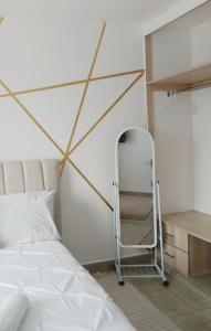 a bedroom with a bed and a ladder next to a shelf at Neema Homes Syokimau in Nairobi
