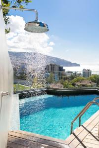 a swimming pool with a water fountain at Green Boat by Madeira Best Apartments in Funchal