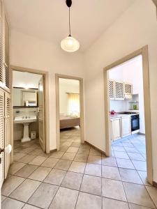 a large room with a kitchen with a sink and a doorway at Kàllistos Suites & Apartments in Gallipoli