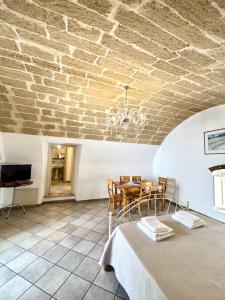 a dining room with a table and a brick ceiling at Kàllistos Suites & Apartments in Gallipoli +125 photos