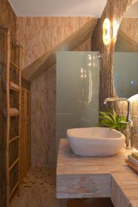 a bathroom with a large white sink on a counter at Miles Away Sifnos - Beachfront House in Platis Yialos Sifnos +49 photos