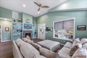 a living room with a couch and a fireplace at Seahorse Shanty in Birch Town
