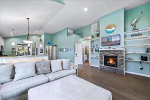 a living room with a couch and a fireplace at Seahorse Shanty in Birch Town +32 photos