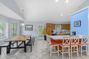 a kitchen and dining room with a table and chairs at 36 Rabbit Run Lane in Ocean Pines +20 photos