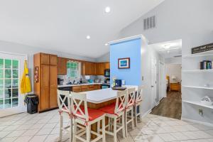 a kitchen with a table and chairs in a room at 36 Rabbit Run Lane in Ocean Pines