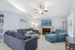 a living room with two blue couches and a fireplace at 36 Rabbit Run Lane in Ocean Pines