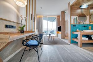 a bathroom with a desk and a chair in a room at HOVIMA Suites Costa Adeje in Adeje