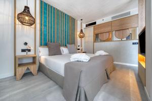 a bedroom with a large bed and a television at HOVIMA Suites Costa Adeje in Adeje