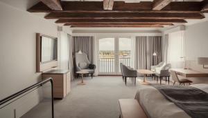 a hotel room with a bed and a desk and chairs at Copenhagen Admiral Hotel in Copenhagen