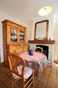 a dining room with a table and a fireplace at Maison du GR34 Baie de Beaussais Classée 1 étoile in Beaussais sur Mer