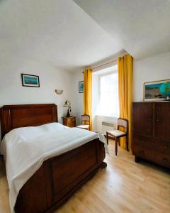 a bedroom with a large bed and a window at Maison du GR34 Baie de Beaussais Classée 1 étoile in Beaussais sur Mer