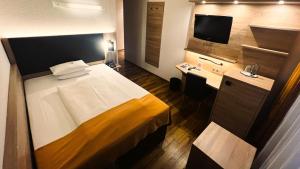 Postel nebo postele na pokoji v ubytování ARVENA Messe Hotel