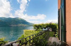 a balcony with a view of a body of water at Villa Lina in Lezzeno