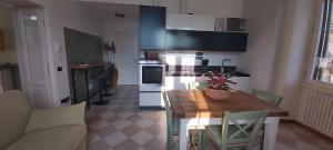 a kitchen with a table and a kitchen with a couch at Casa Beatrice in Oliveto Lario +31 photos