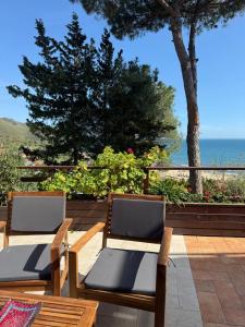 two chairs on a patio with the ocean in the background at Villa Fiorella in Sperlonga +11 photos