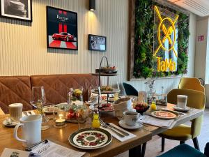 a wooden table with plates of food on it at Scheck Hotel in Munich