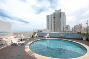a swimming pool on the roof of a building at GuarapariResidence in Guarapari
