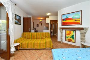 a living room with a bed and a fireplace at Apartments Suzi 2381 in Peroj
