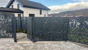 a black iron gate in front of a house at Villa Aldina Apartment 2 in Bihać