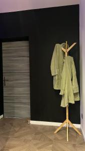 a robe on a stand in front of a door at Chez sousouzen in Dunkerque