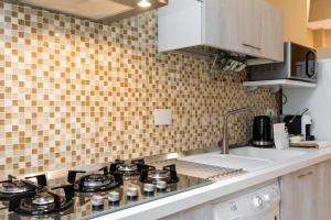 Kuchyň nebo kuchyňský kout v ubytování Dante Experience Apartment