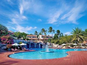 a pool at a resort with a fountain at Phu Hai Beach Resort & Spa Phan Thiet in Mui Ne