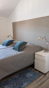 a bedroom with a bed with a large wooden headboard at Lederkappe Apartments in Mühlhausen