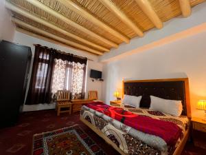 a bedroom with a large bed in a room at Sky land guest house in Leh