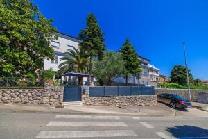 a building with a gate and a stone wall at Apartment Andry 2 in Crikvenica