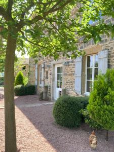 a stone house with a tree in front of it at Bourgeoisie @ Brandon in Brandon