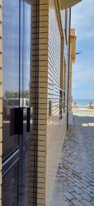 a brick wall of a building with a view of the ocean at Casa da Praia - Family and Friends, Surf and Beach in Vila Praia de Âncora
