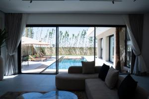 a living room with a couch and a pool at Modern Villa Selma in Marrakesh
