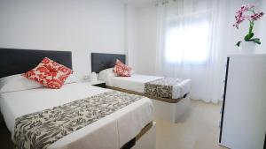 Łóżko lub łóżka w pokoju w obiekcie As Apartamentos Turisticos