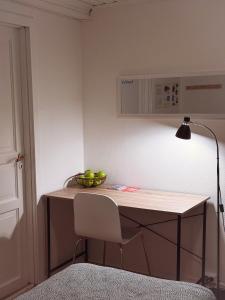 a room with a desk with a bowl of apples on it at Center of Bodø, near the airport and the port to the Lofoten Islands, free coffee in Bodø