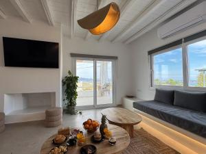 a living room with a couch and a table at La vie est belle luxury apartment BBQ jacuzzi&view in Pounda