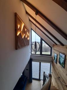 a staircase in a house with a large window at Orawskie wzgórze in Jabłonka
