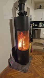 a black stove with a fire in a room at Big House with beautiful city view, gym,BBQ garden and own parking in Žilina +5 photos