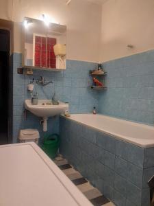 a bathroom with a tub and a sink and a toilet at Big House with beautiful city view, gym,BBQ garden and own parking in Žilina