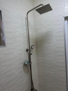 a shower with a shower head in a bathroom at Cottage ELKA gergeti KAZBEGI in (( Gergeti )) +15 photos