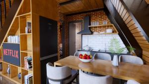 una cucina e una sala da pranzo con tavolo e sedie in legno di Redka Bungalov Resort a Ulupelit